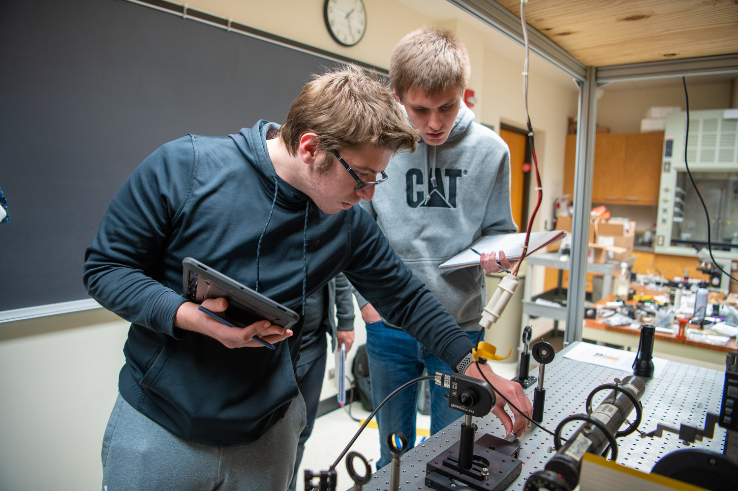 Two college students using small device